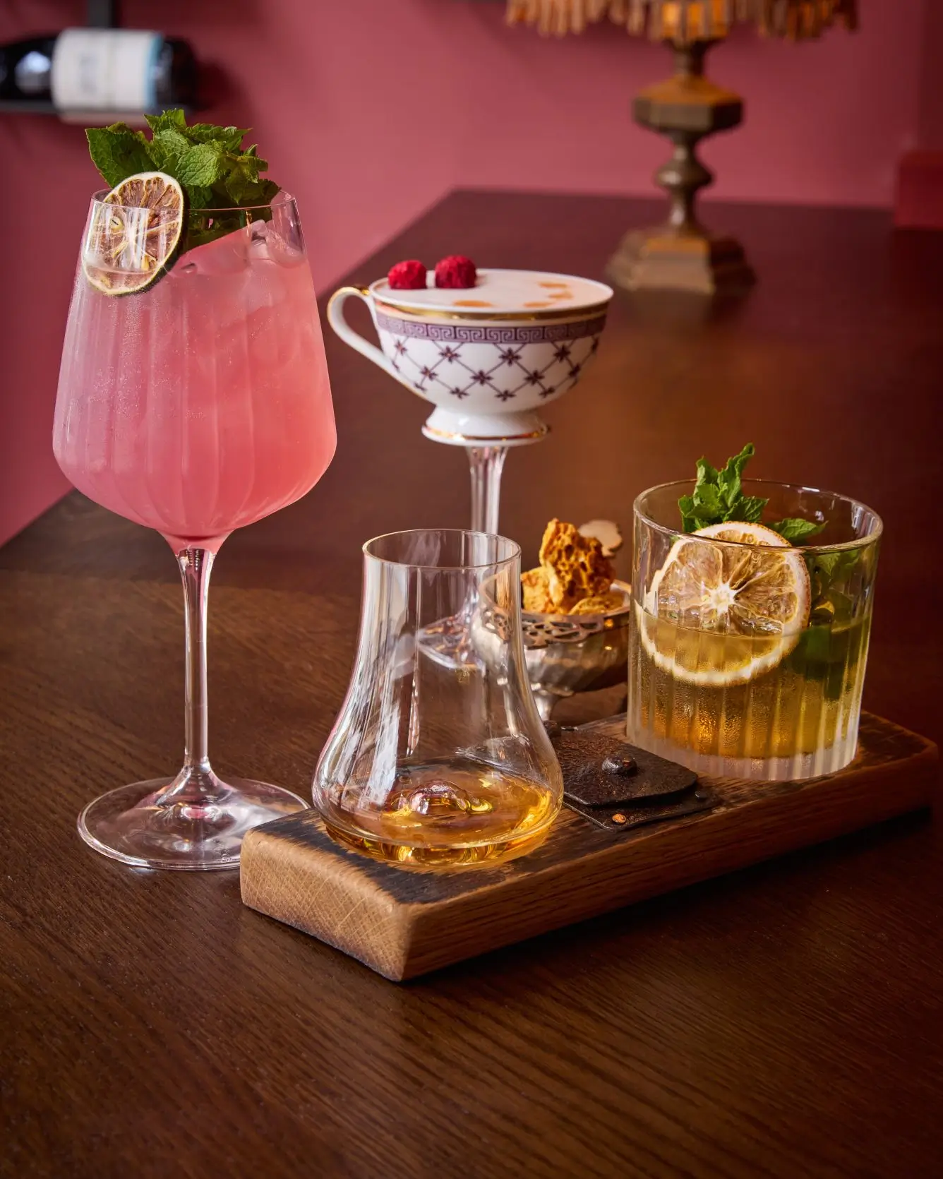 Artisanal & Craft Cocktails | Fitzers Bistro & Bar Dublin A vibrant selection of craft cocktails from Fitzers Bar, including a pink gin drink, a whiskey cocktail, a raspberry foam cocktail, and a glass of neat whiskey.